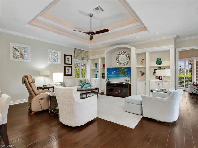 a living room with furniture a fireplace and a window