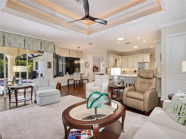 a living room with furniture and a view of kitchen
