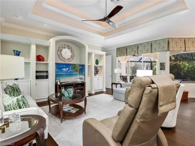 a living room with furniture a window and a fireplace
