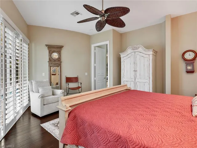 a bedroom with a large bed and a chandelier