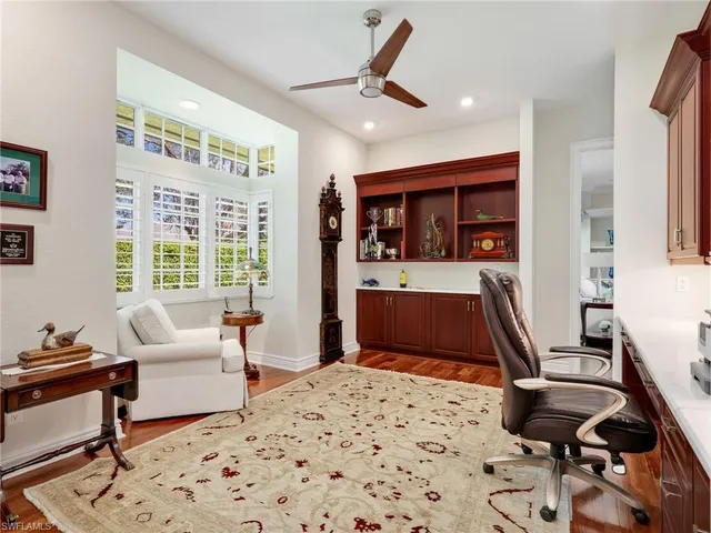 a bedroom with a bed a couch and a large window