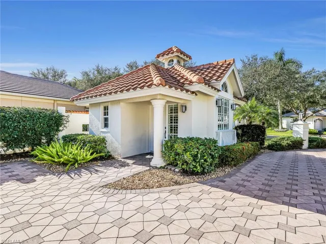a view of a house with a small yard and a garden