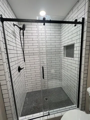 a bathroom with a shower and a sink