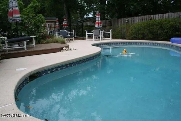 a view of a swimming pool with a patio