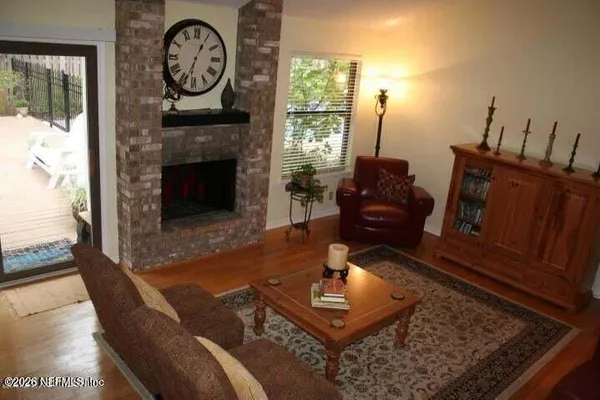 a living room with furniture a window and a fireplace