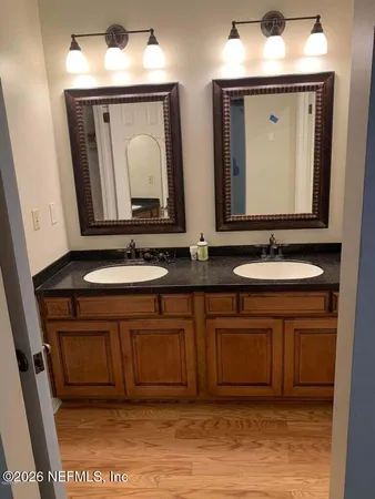 a bathroom with a sink vanity and mirror
