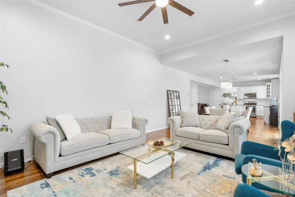 a living room with furniture and a chandelier
