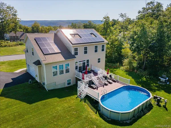 an aerial view of a house with swimming pool garden and patio