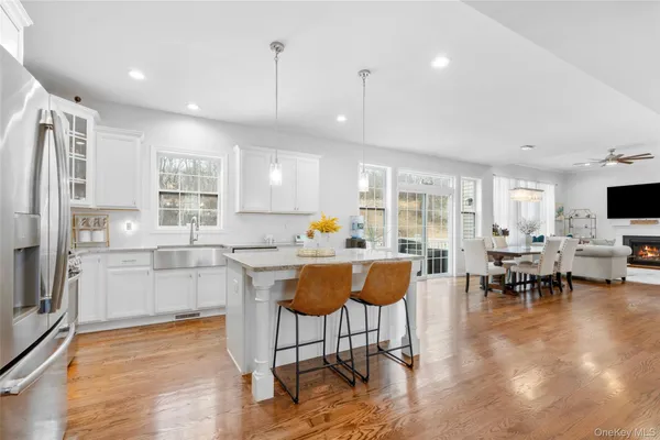 a living room with stainless steel appliances kitchen island granite countertop furniture and a view of kitchen