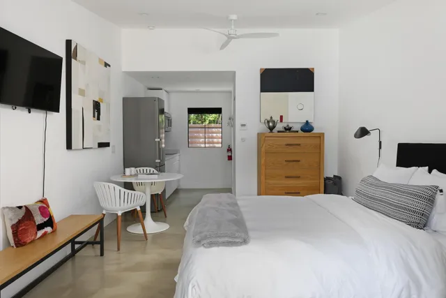 a bedroom with a bed and a large window