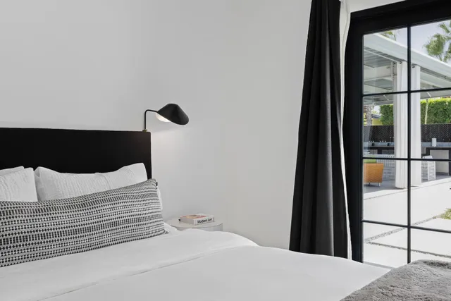 a kitchen with a refrigerator and a chair