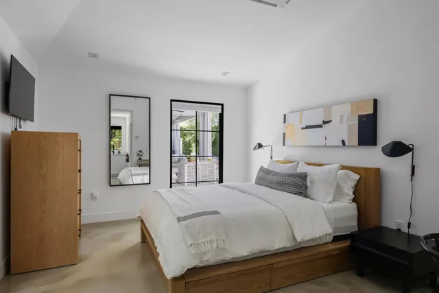 a bedroom with a bed and a flat screen tv