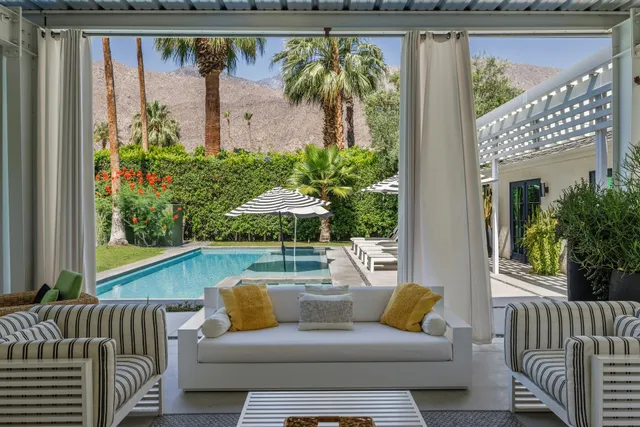a view of a patio with swimming pool table and chairs
