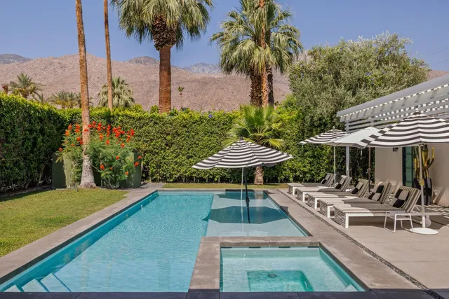 a bedroom with a bed and a refrigerator