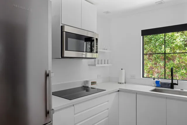 a bedroom with a large bed and a large window