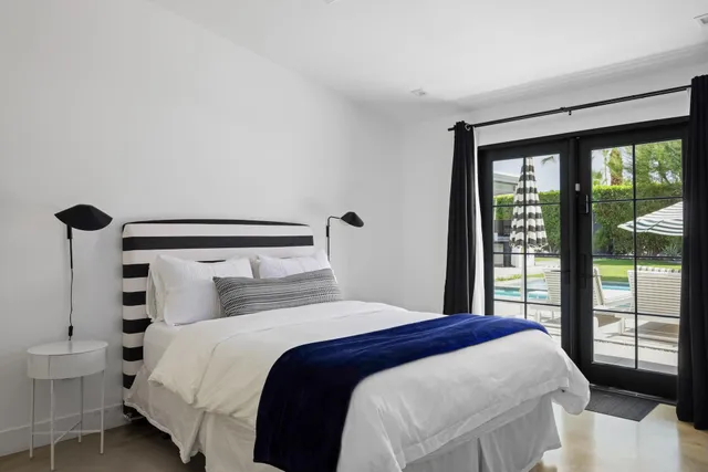 a spacious bedroom with a bed a couch and dresser