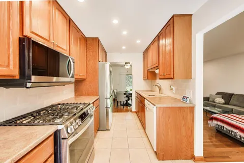 a kitchen with stainless steel appliances a stove a sink and a microwave