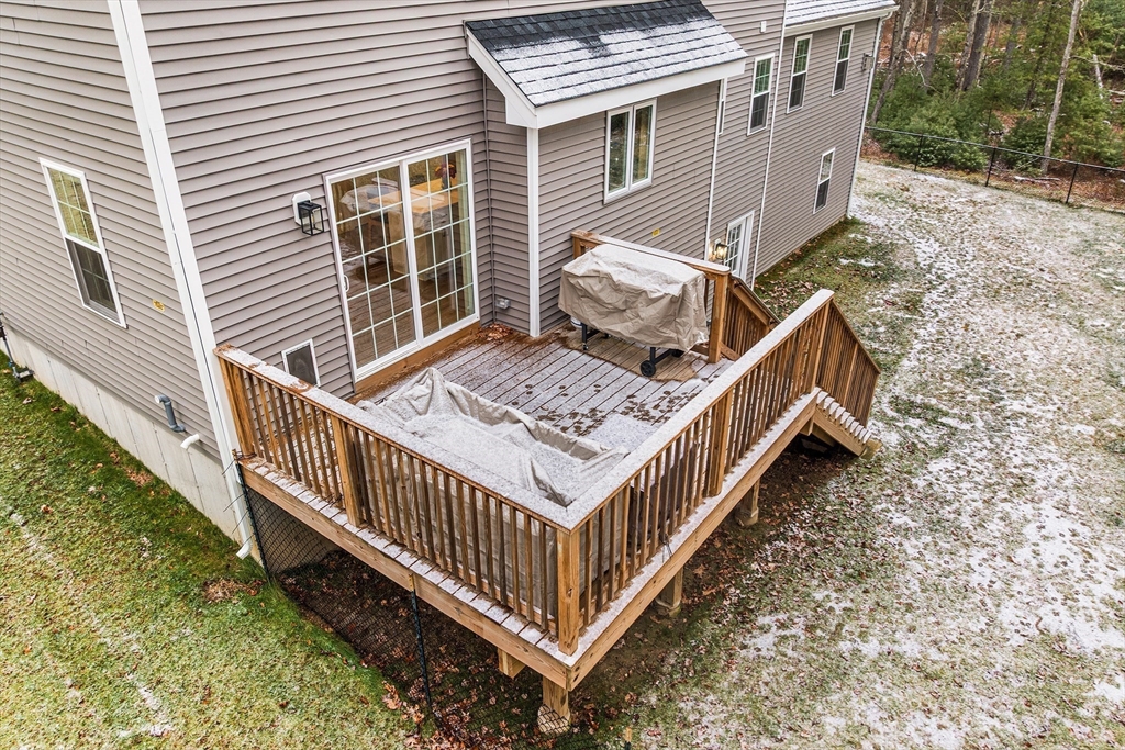 48 Walnut Street Douglas, MA 01516 - Photo 29 of 32 a view of a wooden house with a small yard and wooden deck