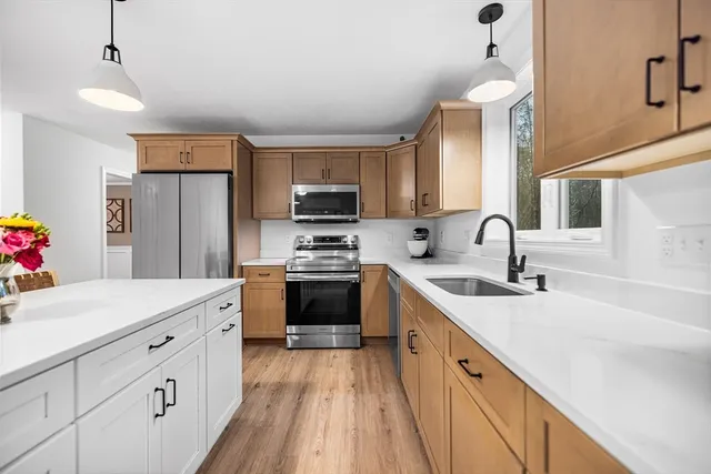 a kitchen with cabinets a sink and appliances