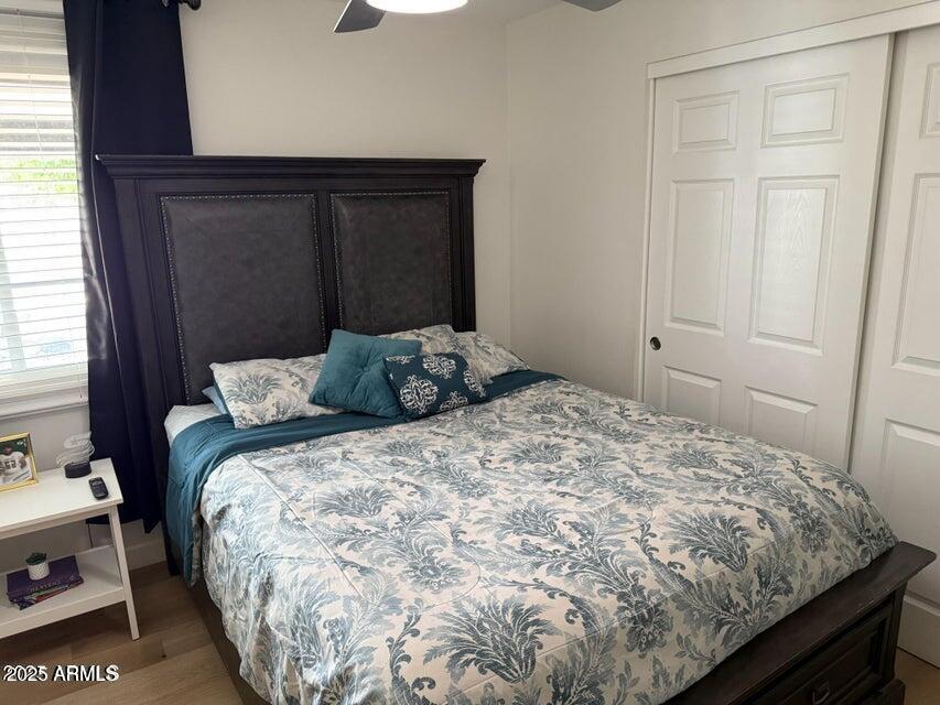 8113 West Osborn Road Phoenix, AZ 85033 - Photo 23 of 35 a bed sitting in a bedroom next to a cabinet
