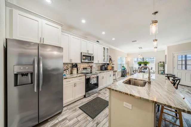 a view of living room kitchen with stainless steel appliances granite countertop living room