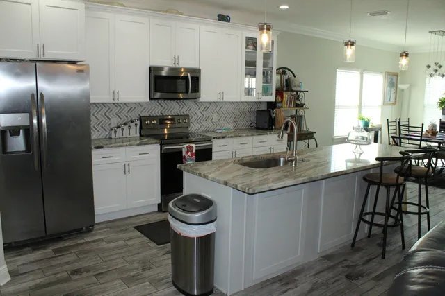 a kitchen with granite countertop a stove and a sink