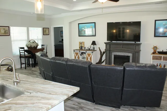 a living room with a fireplace and a flat screen tv