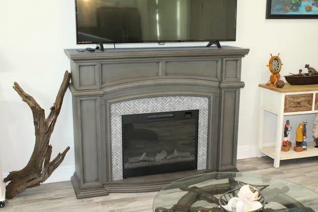 a room with stainless steel appliances kitchen island granite countertop a table chairs stove and refrigerator