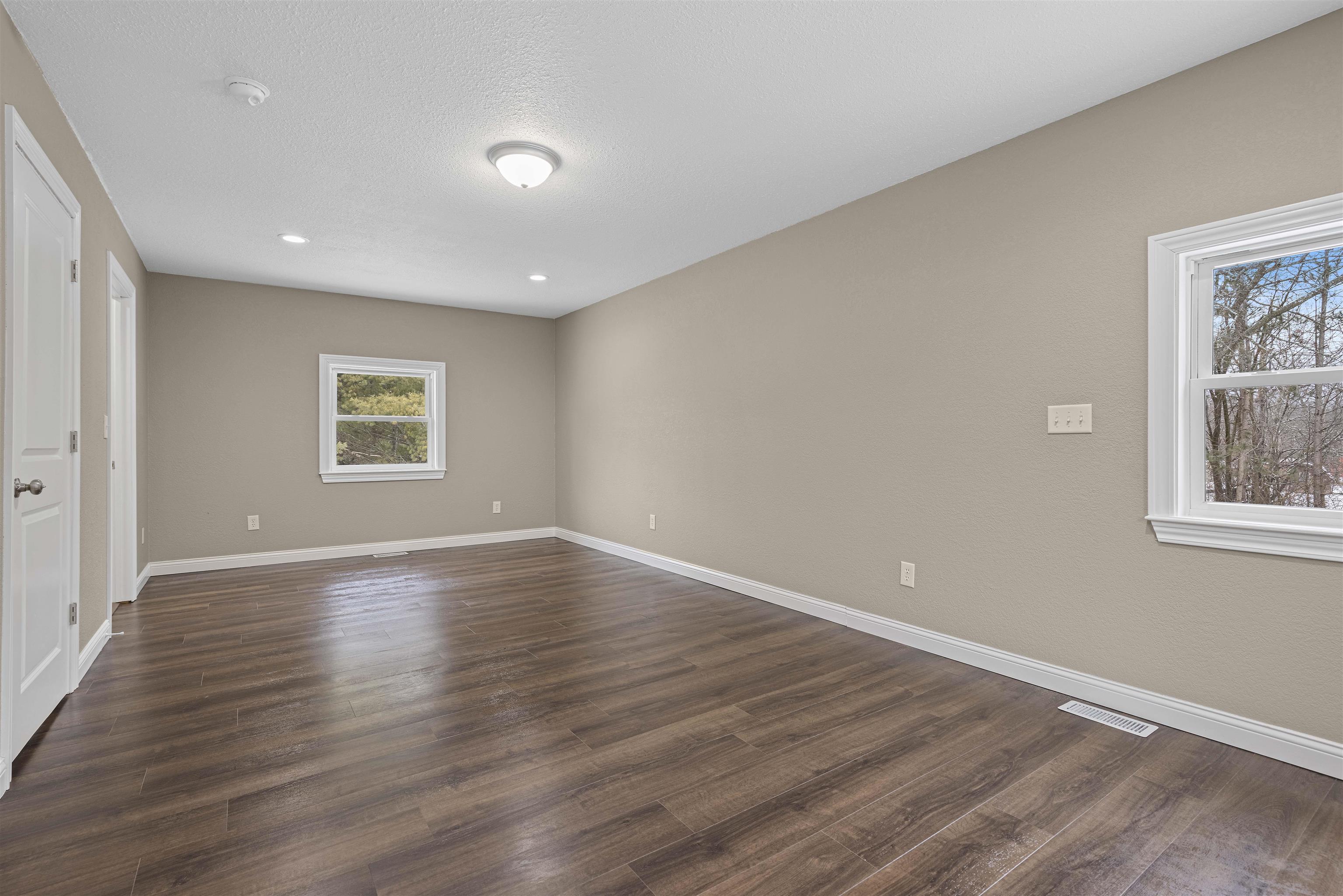6872 Safford Road Rockford, IL 61101 - Photo 13 of 25 a view of an empty room with wooden floor and a window