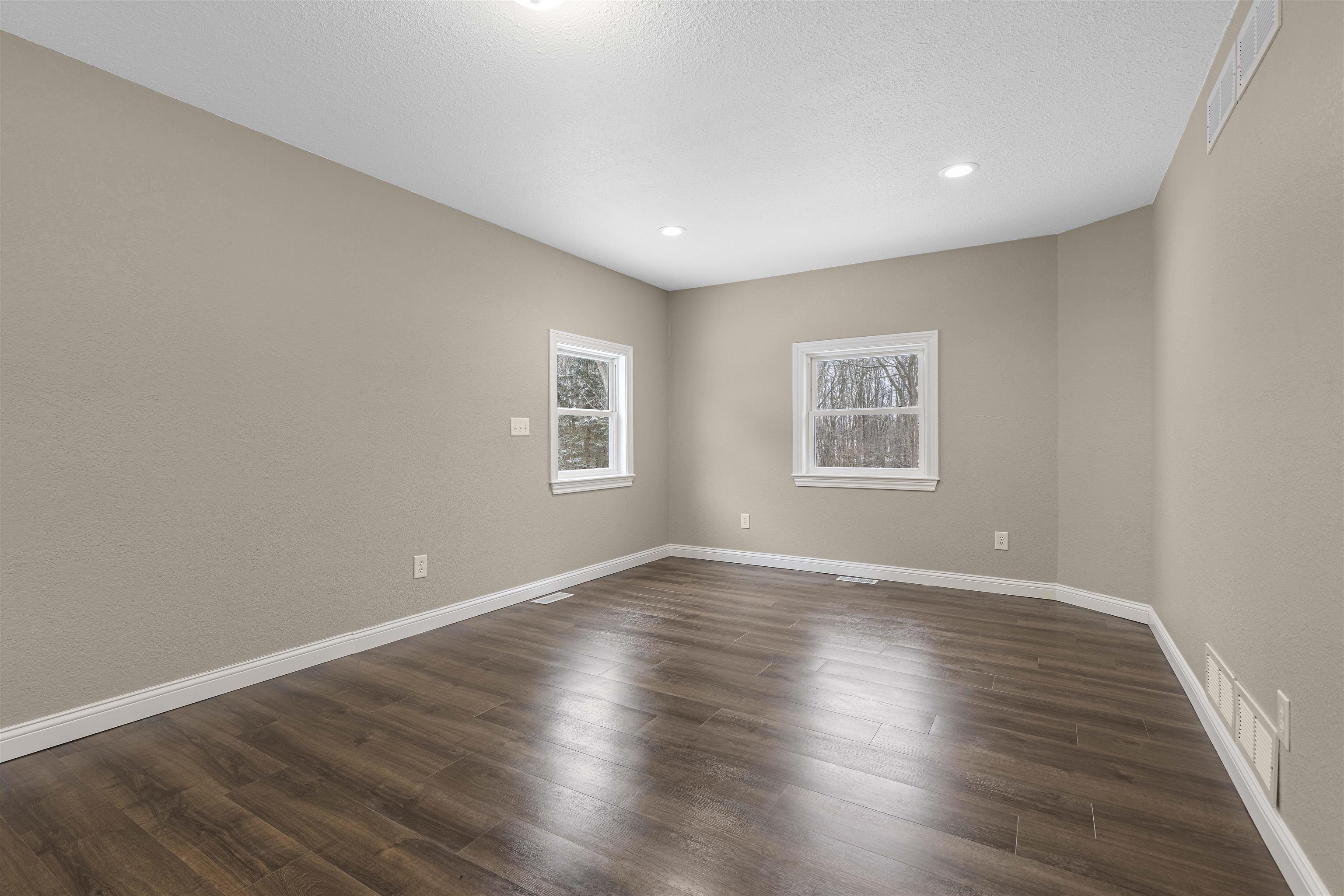 6872 Safford Road Rockford, IL 61101 - Photo 14 of 25 a view of an empty room with wooden floor and a window