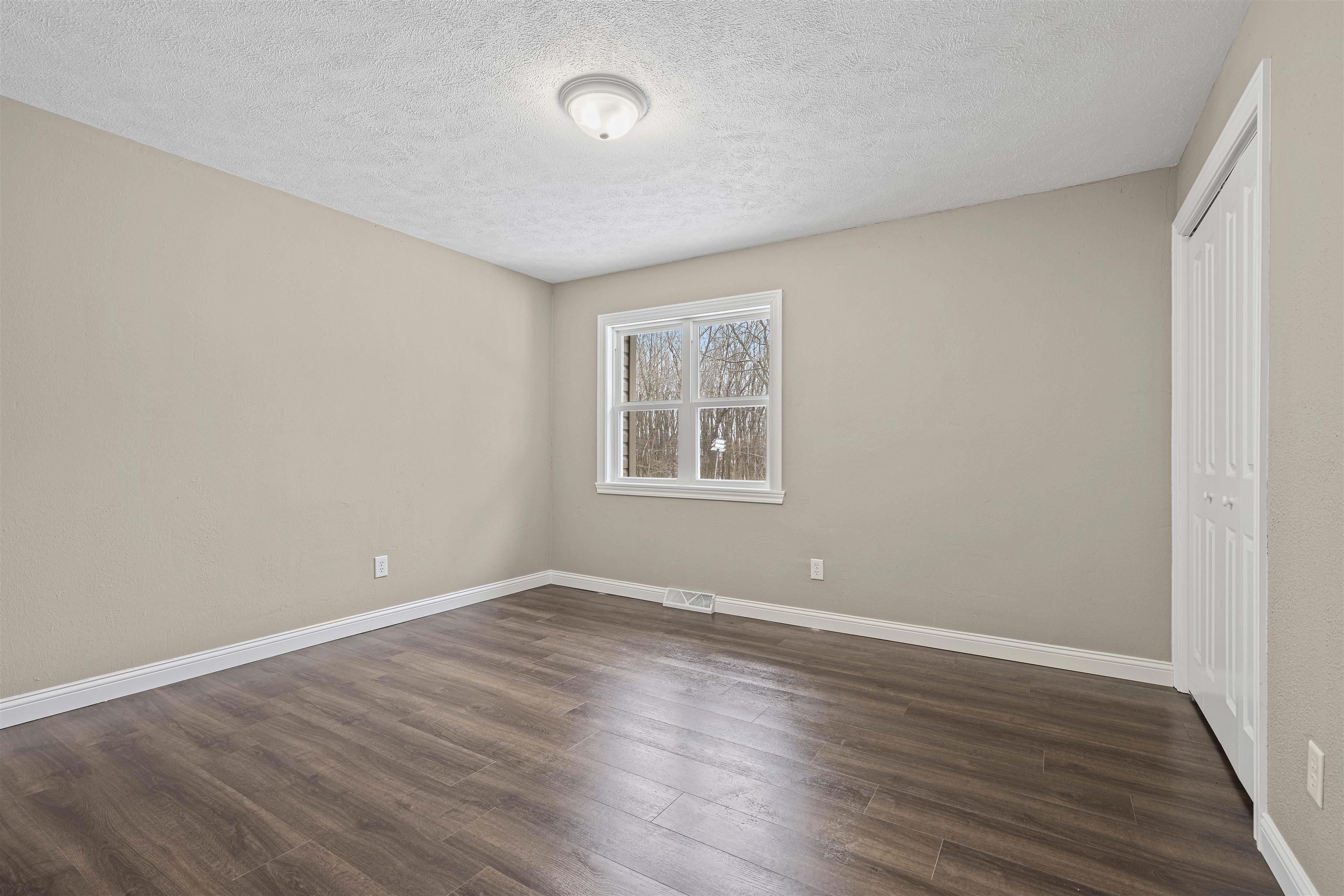 6872 Safford Road Rockford, IL 61101 - Photo 18 of 25 wooden floor in an empty room with a window