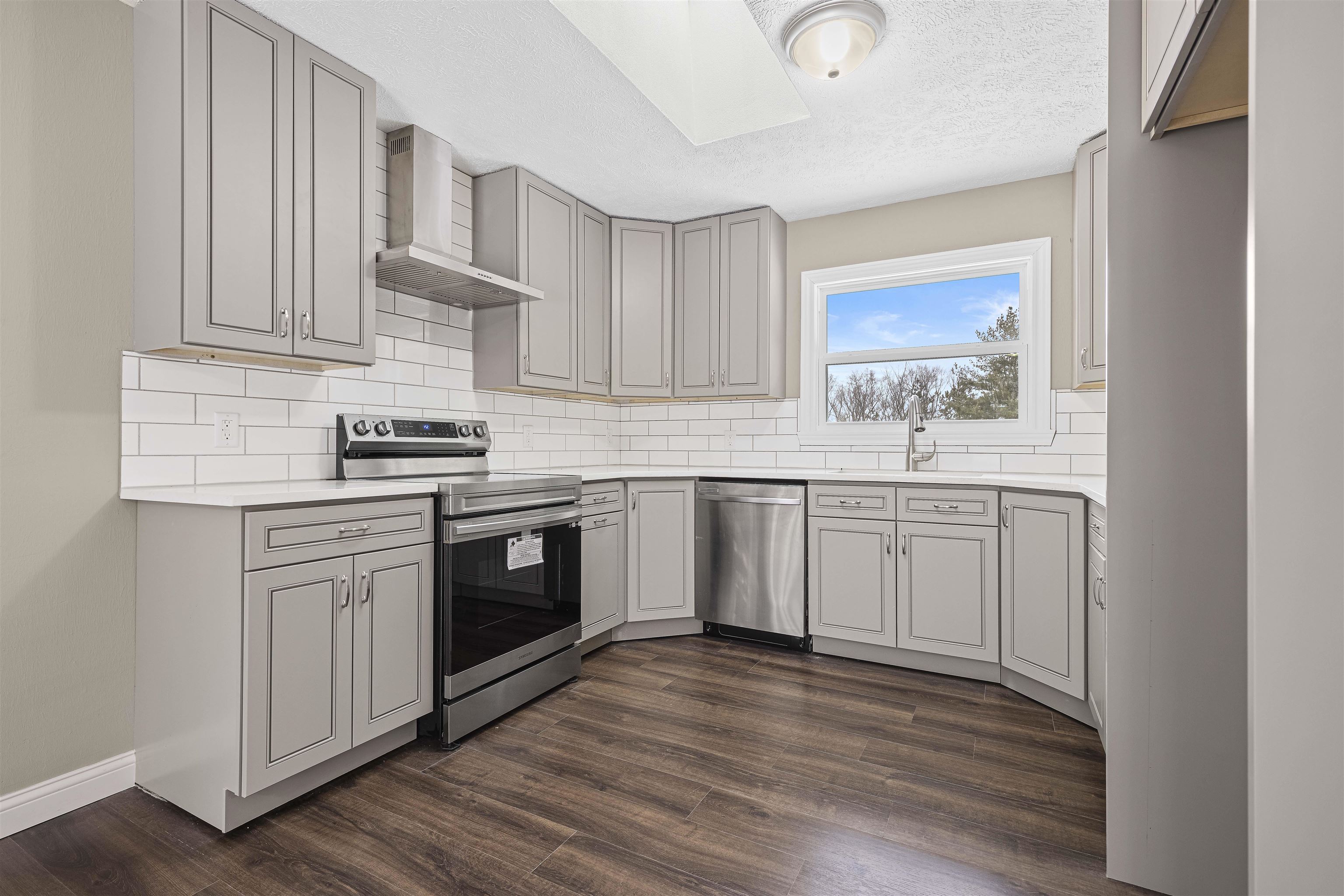 6872 Safford Road Rockford, IL 61101 - Photo 2 of 25 a kitchen with stainless steel appliances granite countertop a sink cabinets and wooden floor