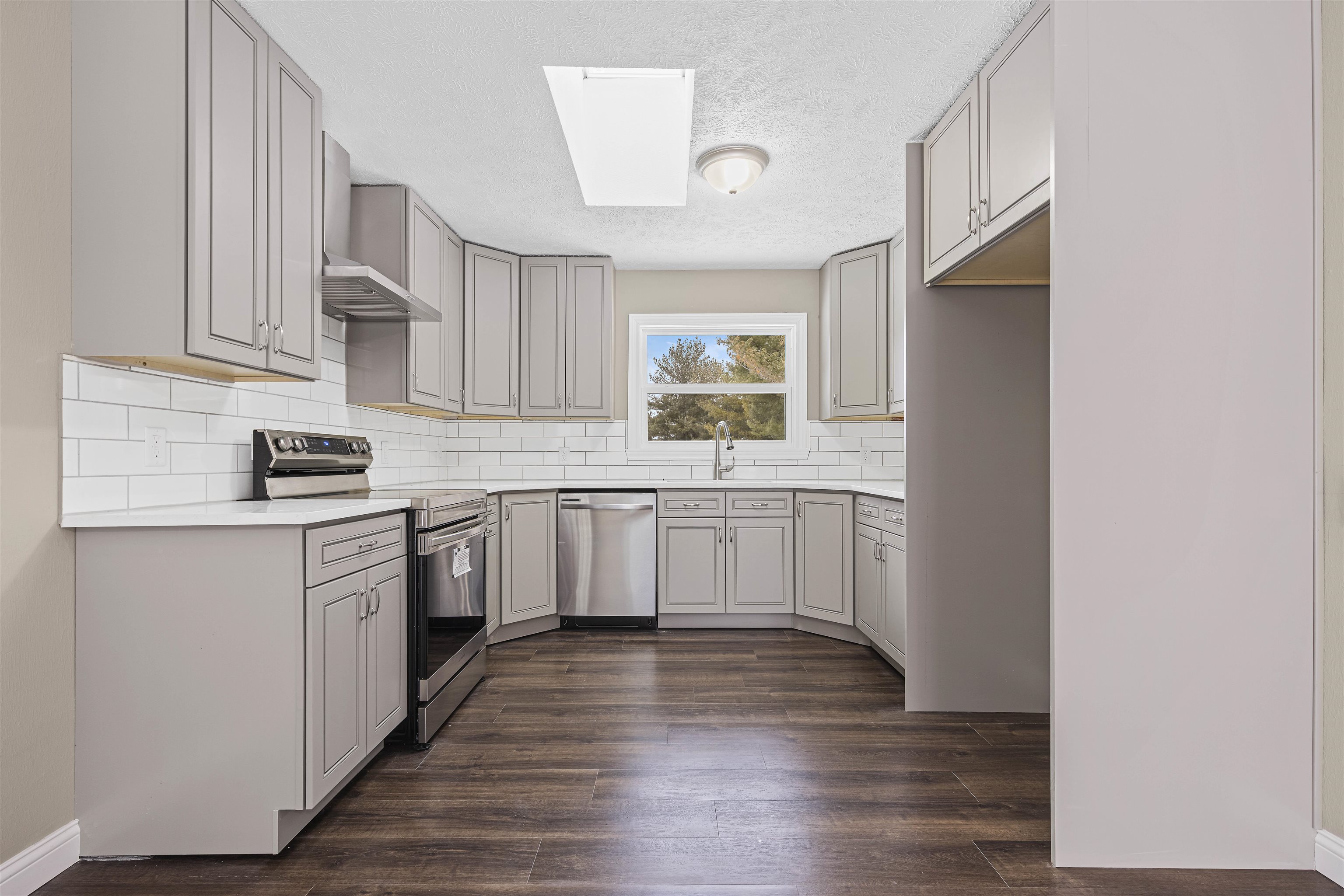 6872 Safford Road Rockford, IL 61101 - Photo 3 of 25 a kitchen with a sink cabinets stainless steel appliances and a window