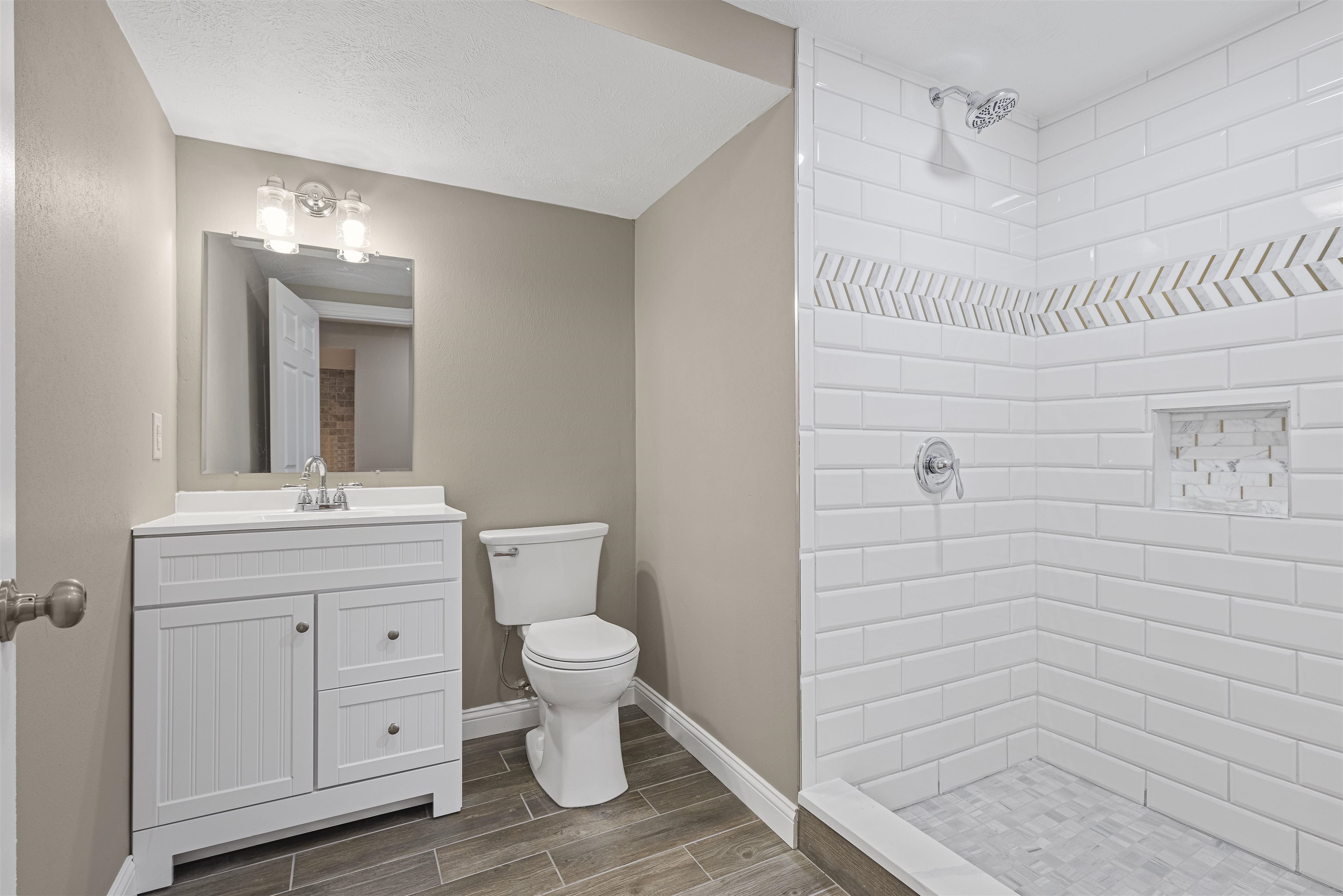 6872 Safford Road Rockford, IL 61101 - Photo 8 of 25 a bathroom with a toilet a sink a mirror and shower