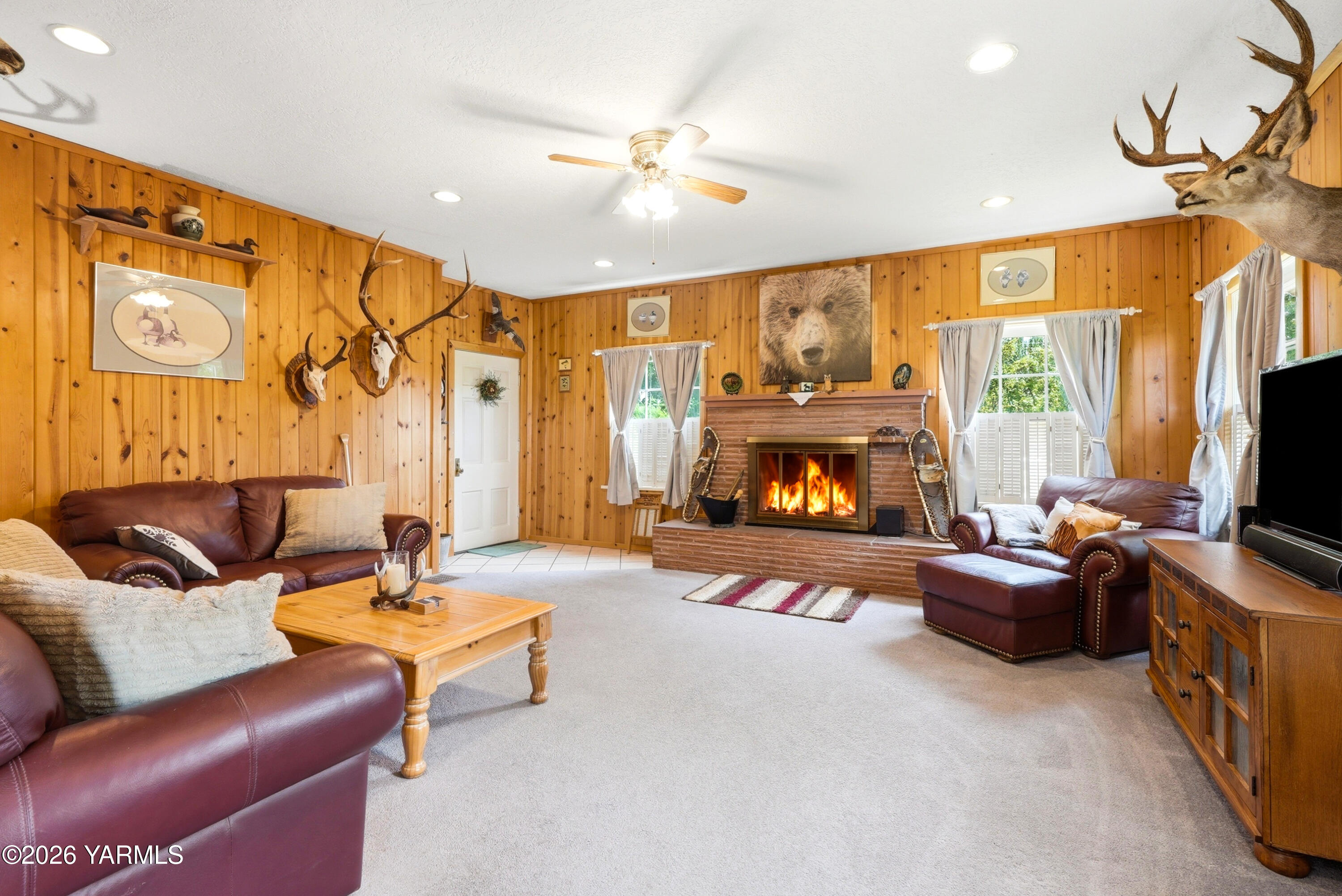 690 North Gleed Road Naches, WA 98937 - Photo 4 of 60 a living room with furniture a flat screen tv and a fireplace
