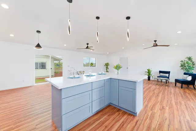 a kitchen with a sink and wooden floor