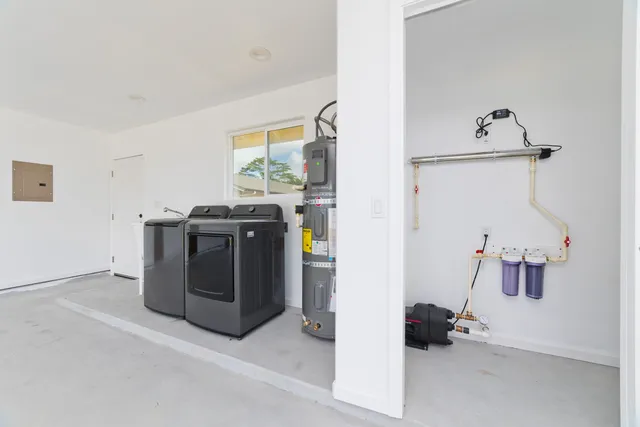 a utility room with a stove washer and dryer