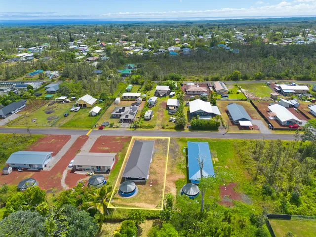 an aerial view of residential houses with outdoor space and swimming pool
