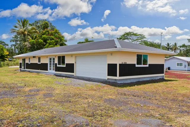 a front view of house with yard garage and entertaining space