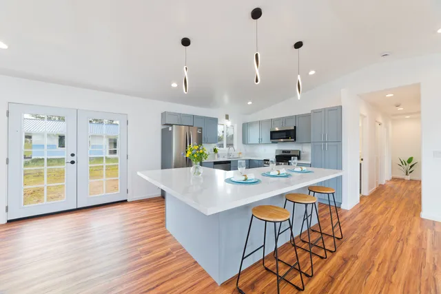 a large kitchen with a table and chairs