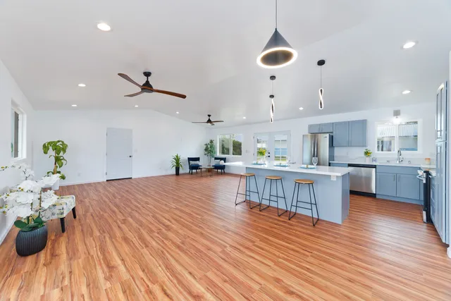 a living room with furniture and kitchen view