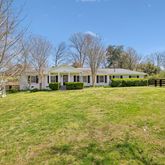 a front view of a building with a yard