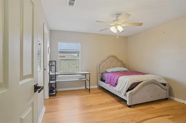 a spacious bedroom with a bed and a chandelier