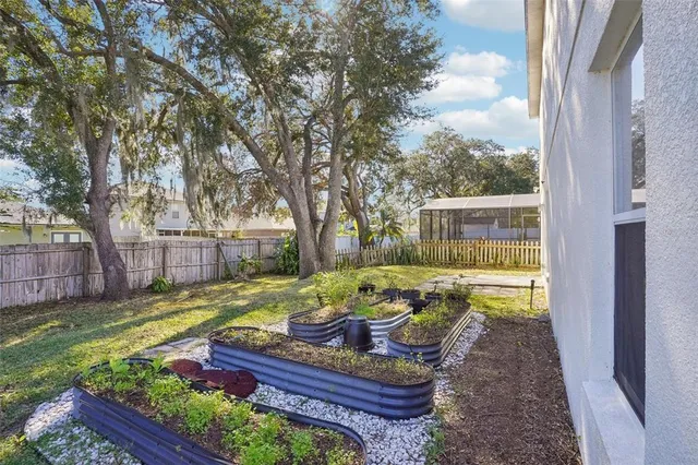 a view of a backyard with couches chair and table