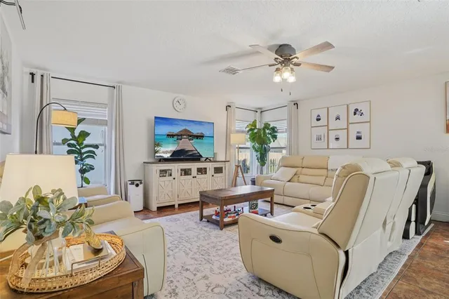 a living room with furniture and a chandelier