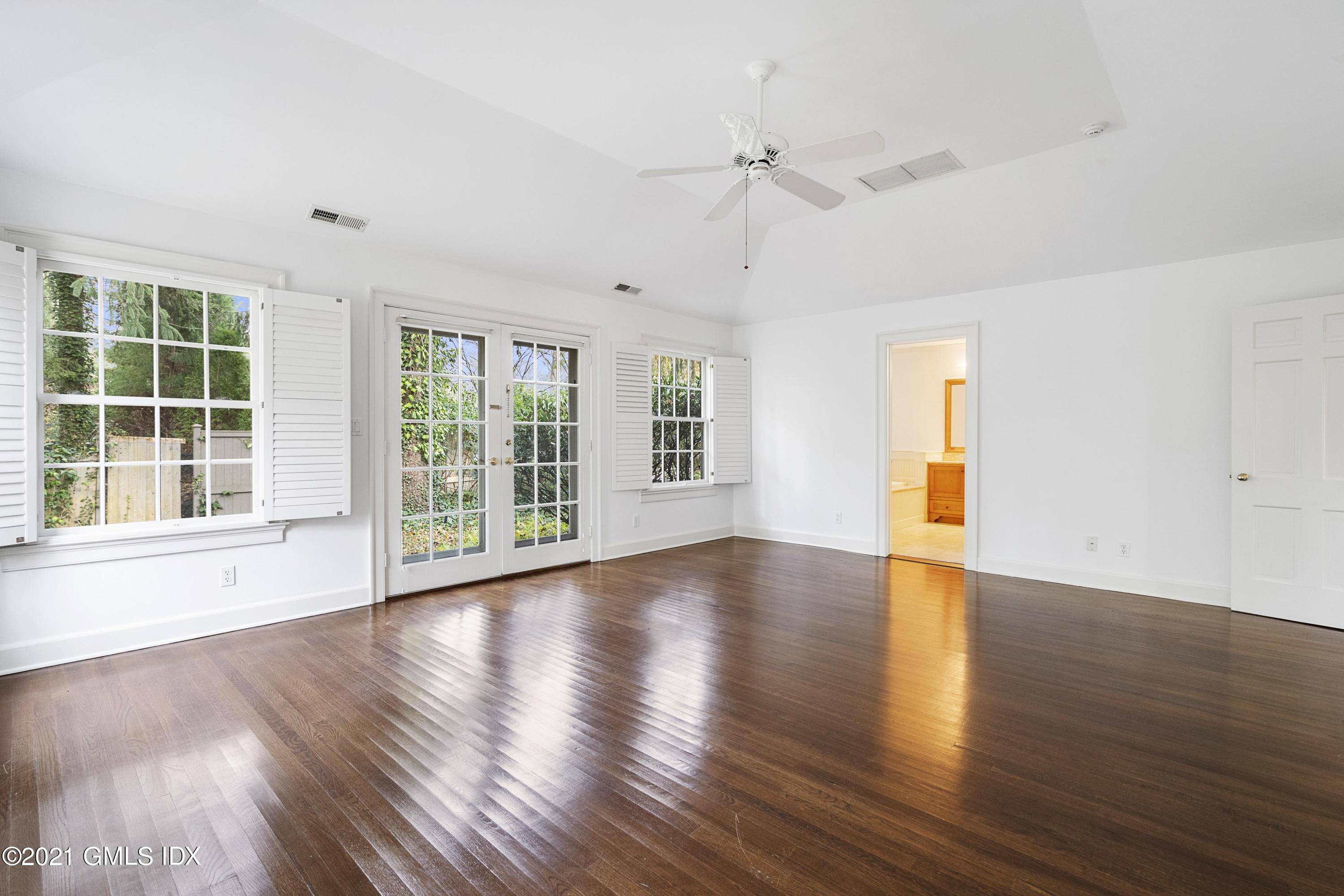 42 Indian Head Road Riverside, CT 06878 - Photo 13 of 47 a view of an empty room with wooden floor and a window