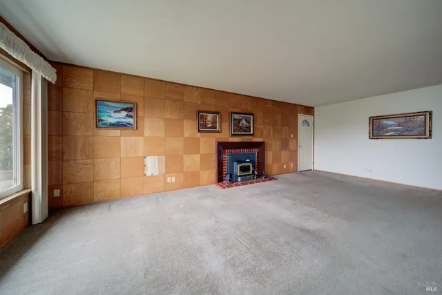 a view of an empty room with a fireplace