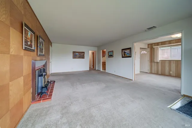 a view of hallway with furniture and a refrigerator