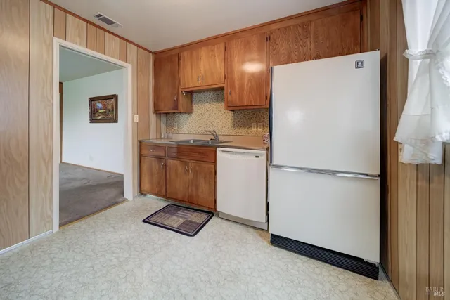 a kitchen with stainless steel appliances a refrigerator and a sink