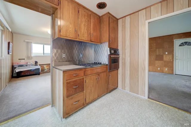 a kitchen with a sink a stove and cabinets